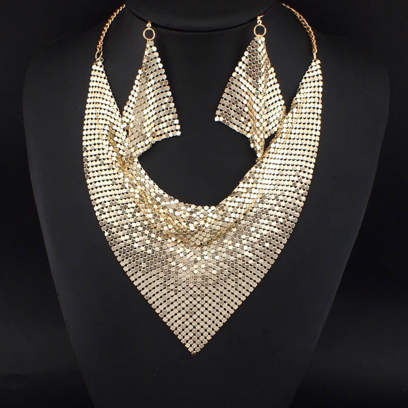 Gold mesh scarf necklace on a black mannequin