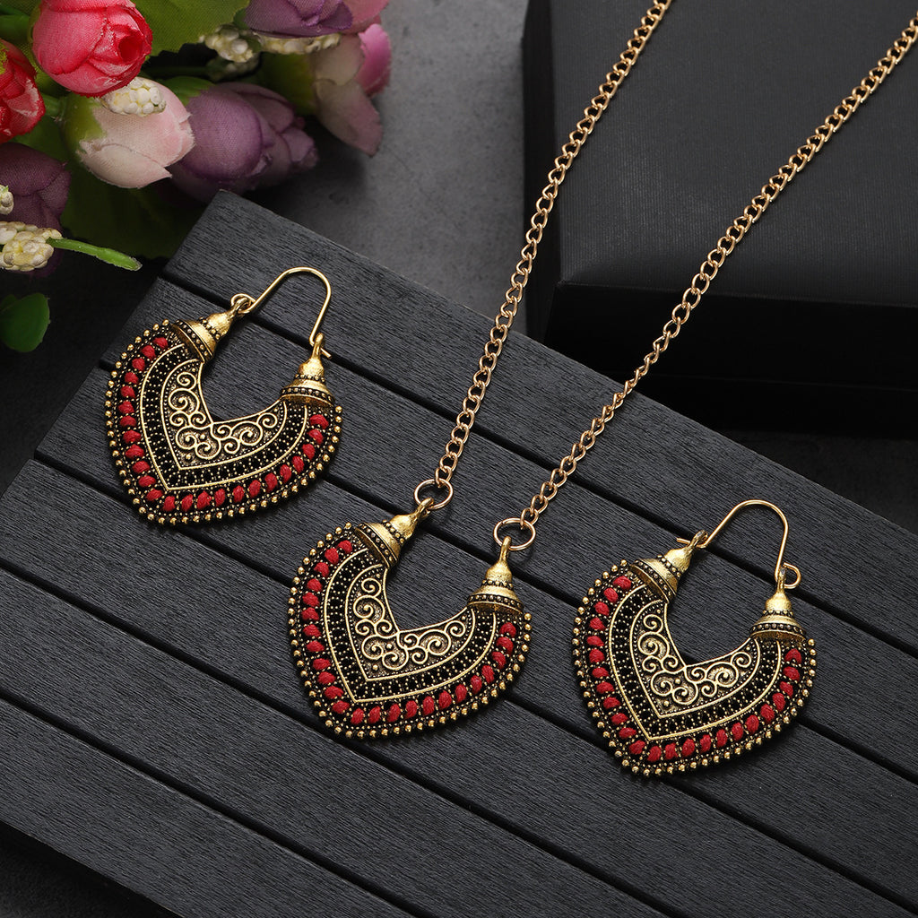 Ornate gold and red heart-shaped earrings and necklace set