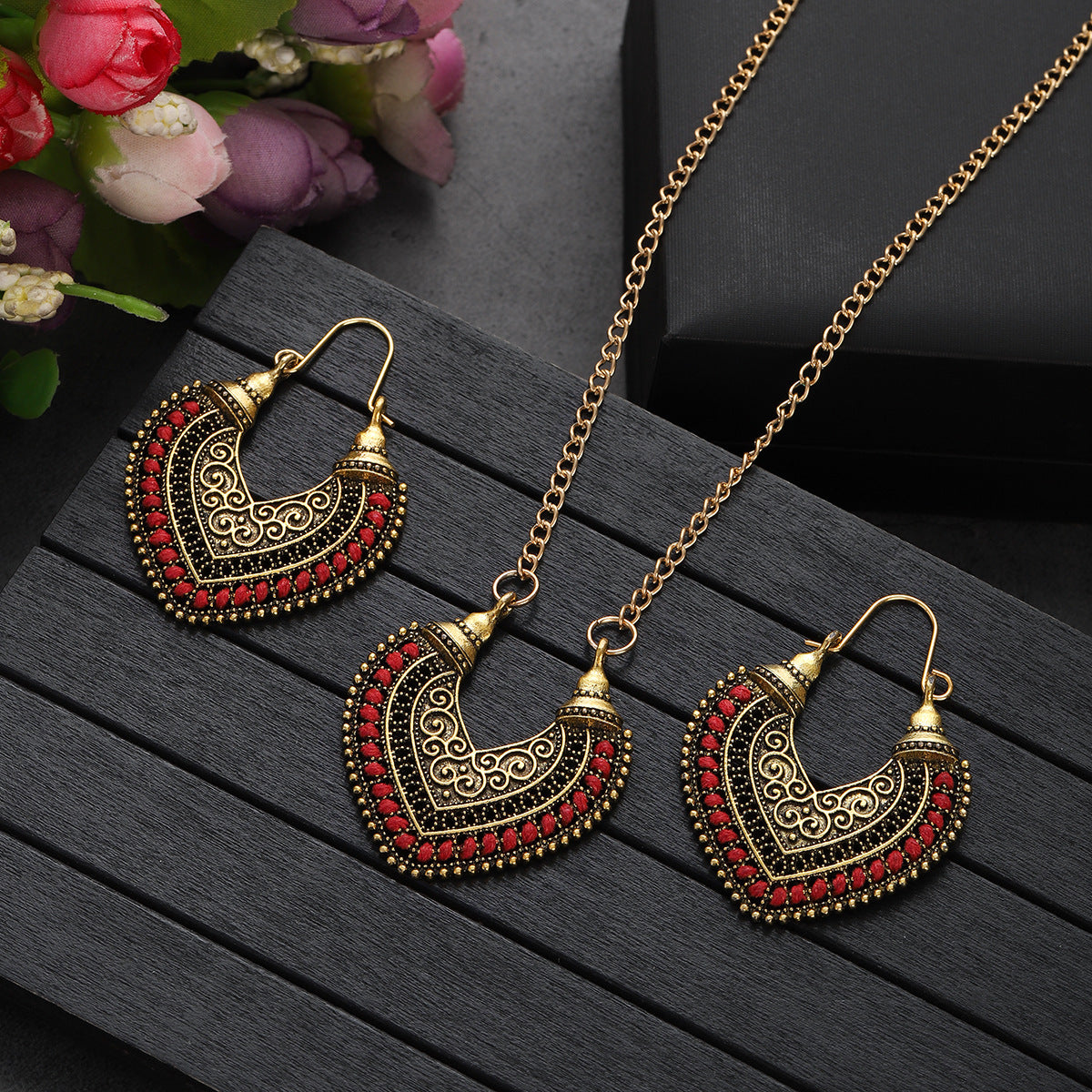 Ornate gold and red heart-shaped earrings and necklace set