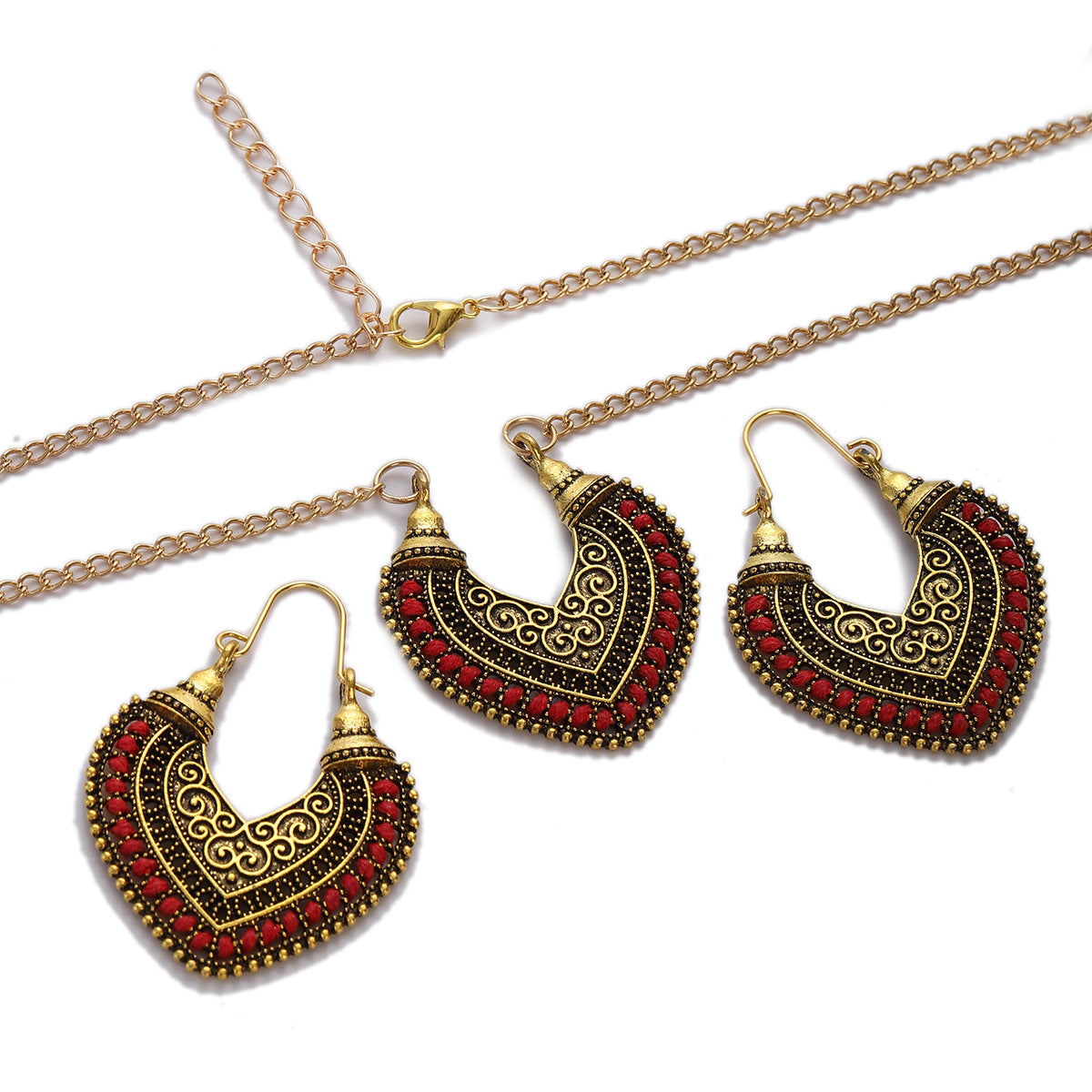 Ornate gold and red heart-shaped earrings with a necklace