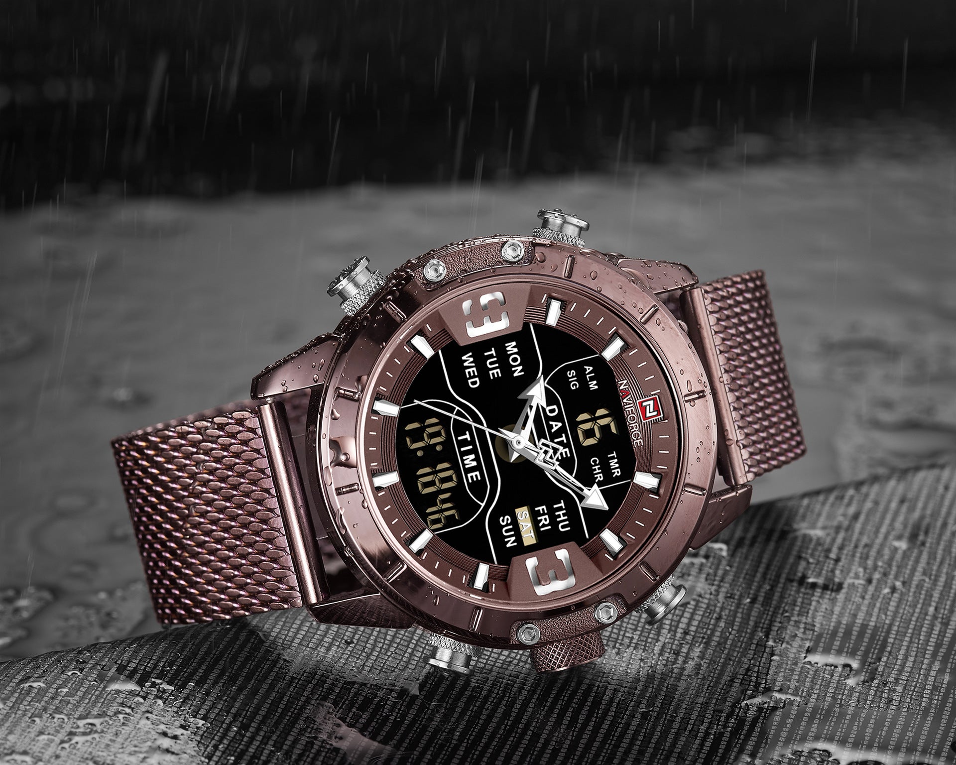 Rose gold mens sport watch with digital display on a textured surface