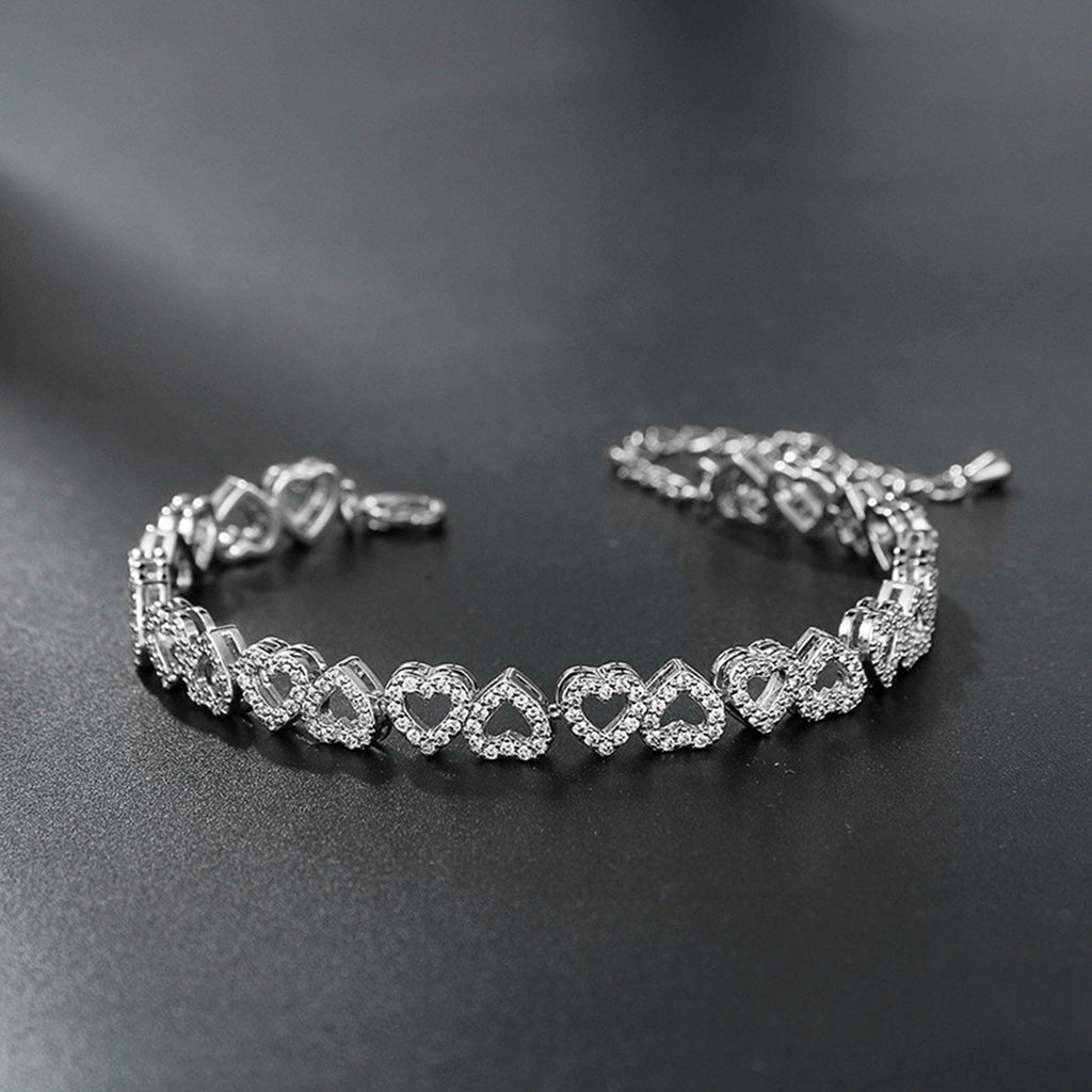 Silver diamond heart bracelet on a dark surface