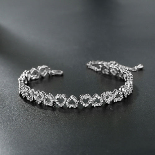 Silver diamond heart bracelet on a dark surface